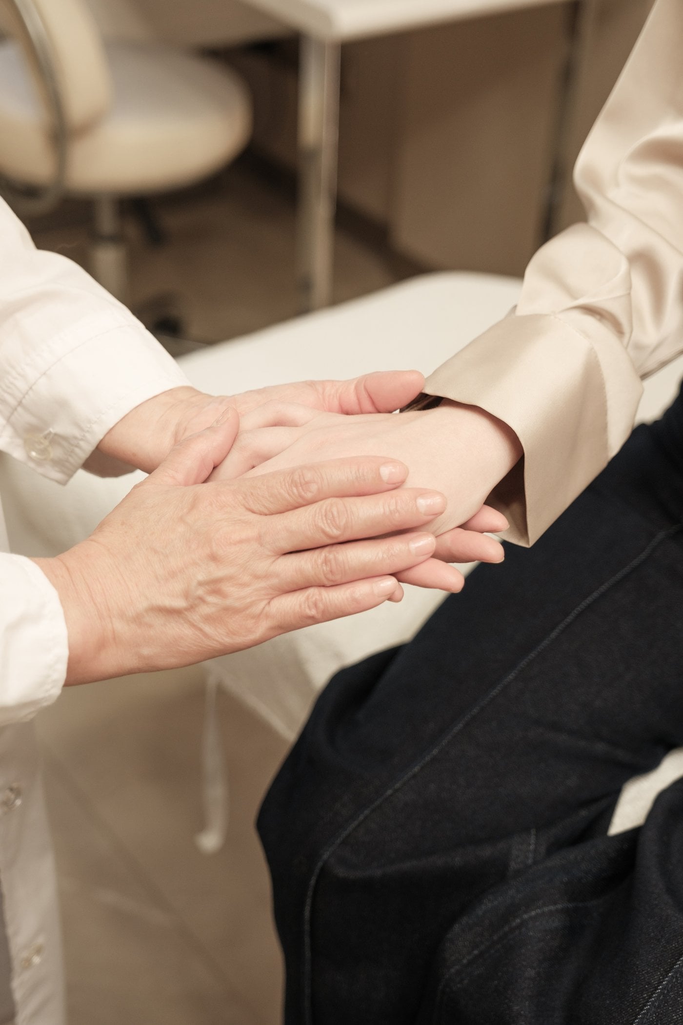Caring hands holding in a supportive disability care setting