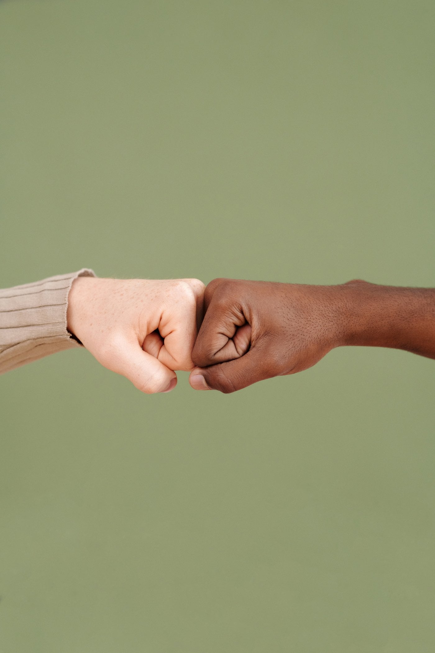 Diverse fist bump showing cultural unity and respect