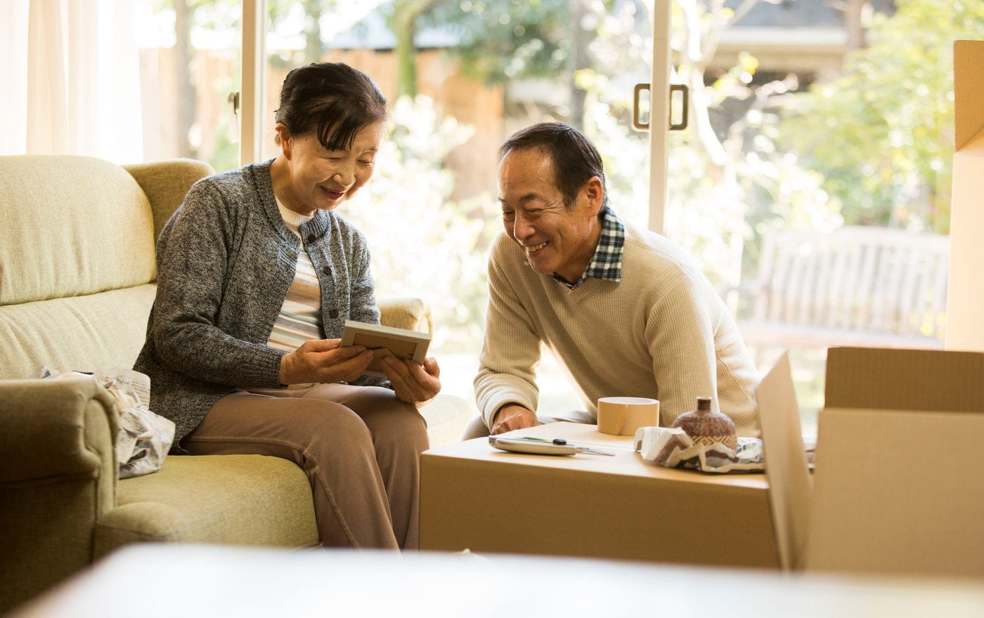 Elderly couple enjoying independent living together on couch at home
