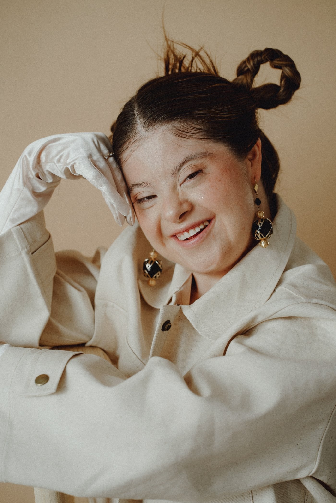 Fashionable young woman with Down syndrome smiling confidently