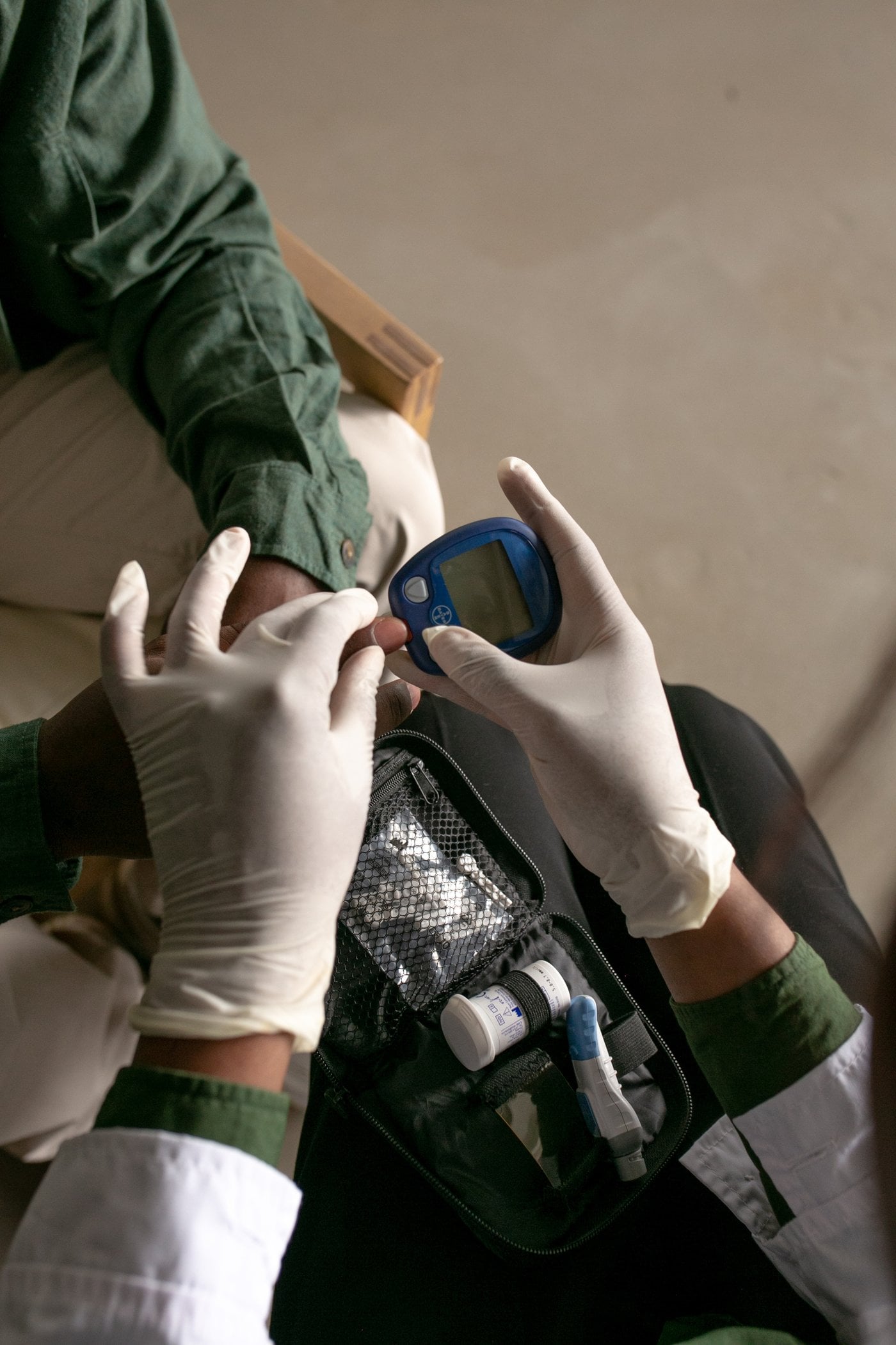 Nurse checking blood glucose levels for a patient
