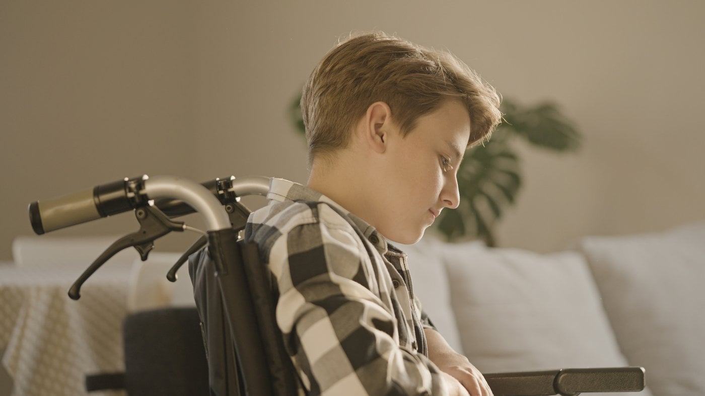 Young person in wheelchair living independently at home
